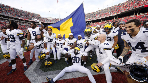 Michigan players plant the flag at Ohio Stadium