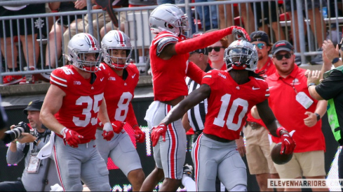 Denzel Burke celebrates his interception