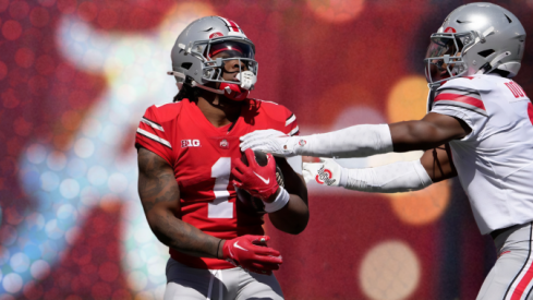 April 13, 2024; Columbus, Ohio, USA; Ohio State Buckeyes running back Quinshon Judkins (1) of the scarlet team is tagged by Caleb Downs (2) of the grey team during the first half of the LifeSports spring football game at Ohio Stadium on Saturday.