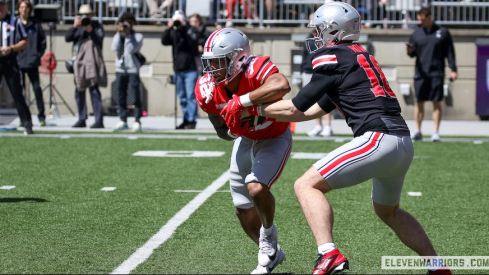 TreVeyon Henderson taking a handoff from Will Howard