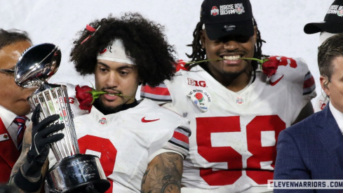 Lathan Ransom and Ty Hamilton celebrate Ohio State's 41-21 Rose Bowl Game victory over Oregon with the Leishman Trophy