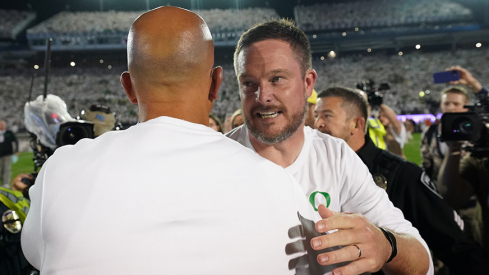 Dan Lanning and James Franklin embrace after Oregon's double-overtime win at Penn State on Saturday, September 26, 2025