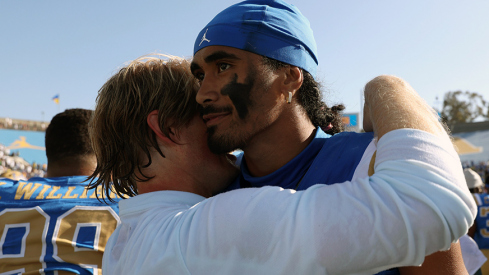UCLA Bruins quarterback Nico Iamaleava (9,right) hugs new offensive coordinator Jerry Neuheisel after defeating the Penn State Nittany Lions 42-37 at Rose Bowl