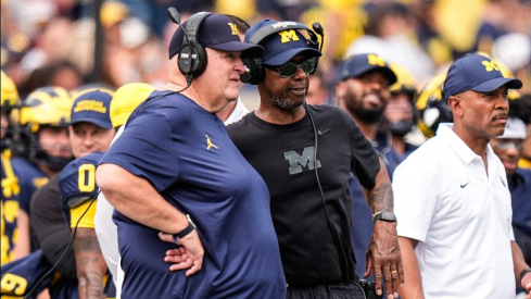 Michigan acting head coach Biff Poggi talks to senior offensive analyst Fred Jackson during the second half against Central Michigan at Michigan Stadium in Ann Arbor on Saturday, Sept. 13, 2025.