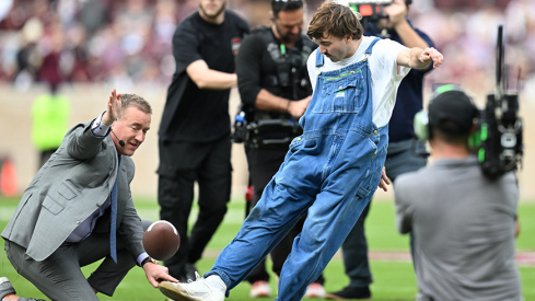 A fan kicks a field goal before the Texas A&M and Miami game