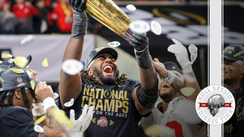 Donovan Jackson hoisting CFP trophy