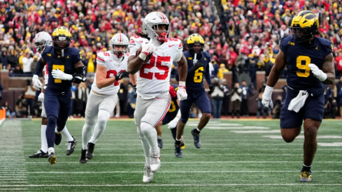 Ohio State Buckeyes running back Bo Jackson (25) runs past Michigan Wolverines defensive end Cameron Brandt (9) during the NCAA football game at Michigan Stadium in Ann Arbor, Mich. on Nov. 29, 2025. Ohio State won 27-9.