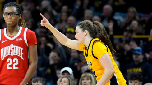 Iowa’s Taylor Stremlow celebrates a 3-pointer as she runs past Ohio State’s Jaloni Cambridge