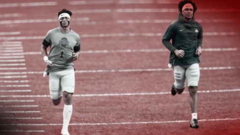 Jan 1, 2021; New Orleans, LA, USA; Ohio State Buckeyes quarterback Justin Fields (1) and quarterback C.J. Stroud (14) warm up prior to the College Football Playoff semifinal against the Clemson Tigers at the Allstate Sugar Bowl in the Mercedes-Benz Superdome in New Orleans on Friday, Jan. 1, 2021. Mandatory Credit: Adam Cairns-Imagn Images