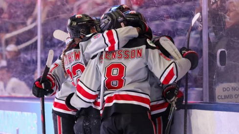 Ohio State women's hockey players embrace after a goal