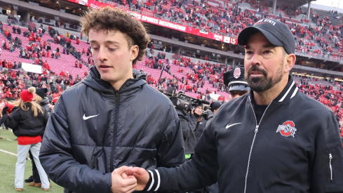 Nov 23, 2024; Columbus, Ohio, USA; Ohio State Buckeyes head coach Ryan Day celebrates with his son RJ Day (left) following the win against the Indiana Hoosiers at Ohio Stadium. Mandatory Credit: Joseph Maiorana-Imagn Images