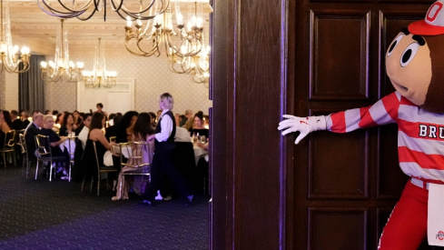Brutus Buckeye tiptoes into a wedding at the Athletic Club of Columbus on Nov. 21, 2025.