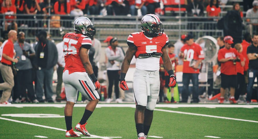 Raekwon McMillan goes hard; Cam Burrows (55) on the left.