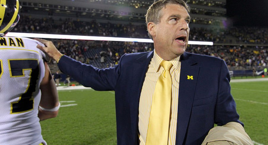 Dave Brandon, likely consoling a Michigan Man after a loss