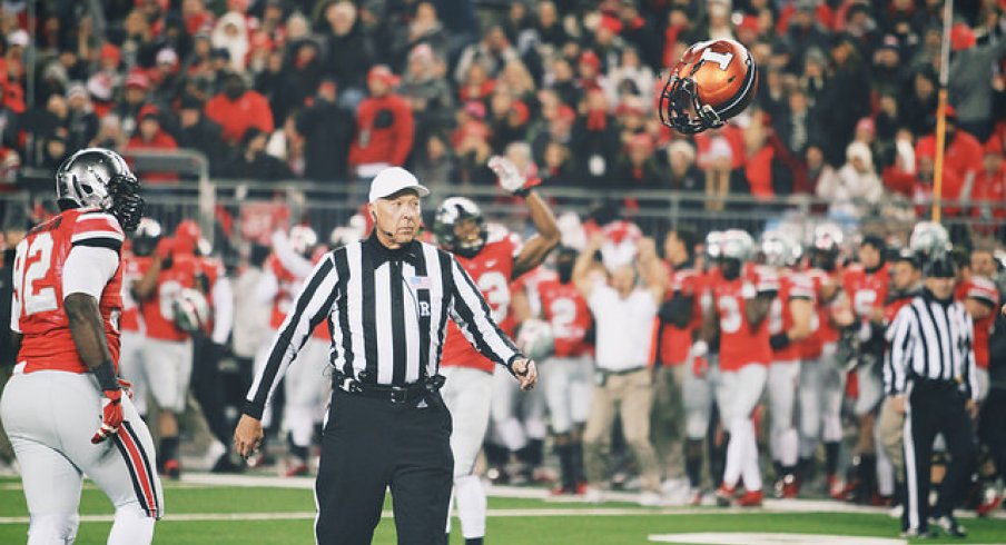 Adolphus Washington watches an Illini helmet take flight