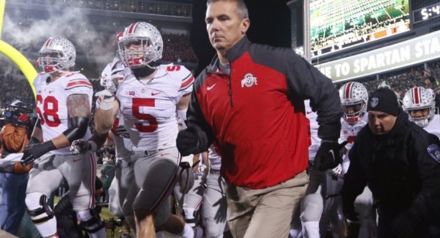 Urban Meyer and the Buckeyes take the field in East Lansing