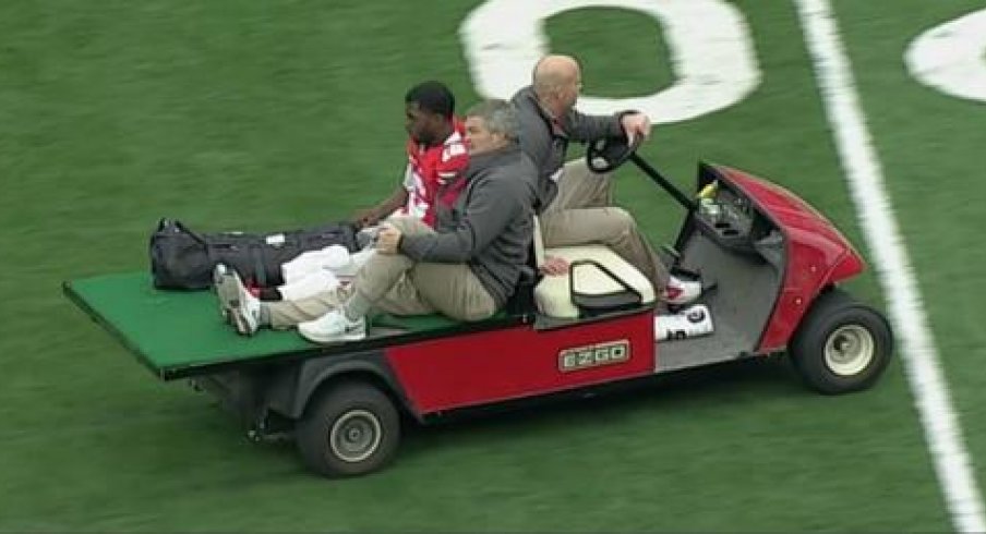 Ohio State quarterback J.T. Barrett carted off the field after injury against Michigan.