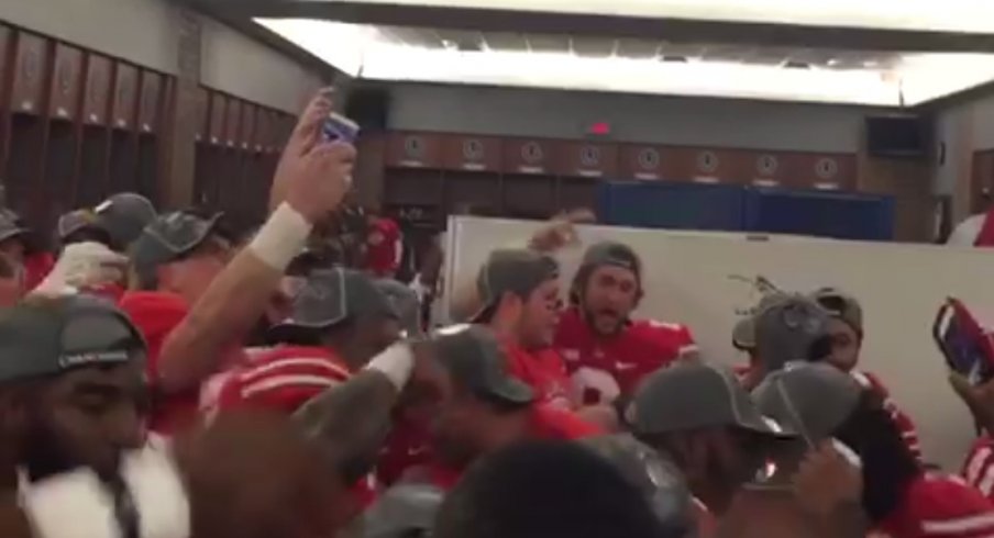 The Ohio State football team celebrates in the locker room following their 59–0 drubbing of Wisconsin.