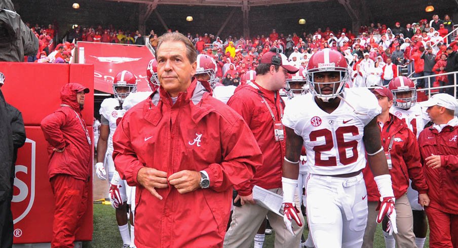 Alabama coach Nick Saban walks out on to the field with safety Landon Collins