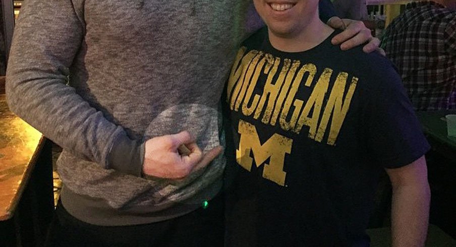 Former Ohio State tight end poses – full bird – with a man wearing a Michigan t-shirt.