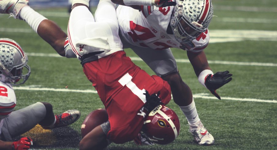 Darron Lee and Doran Grant combine for a tackle.