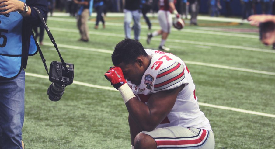 Joshua Perry takes a knee after beating Alabama.