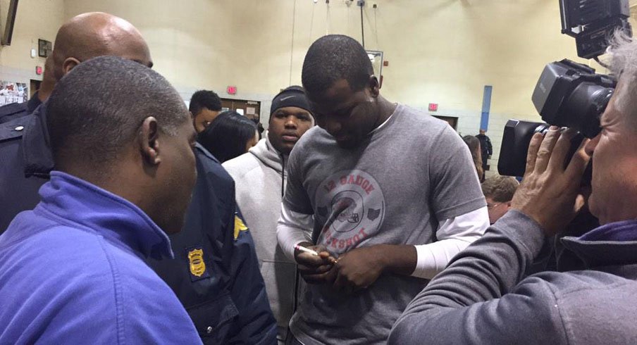 Cardale Jones signing autographs after announcing his intention to return to Ohio State for his junior season.