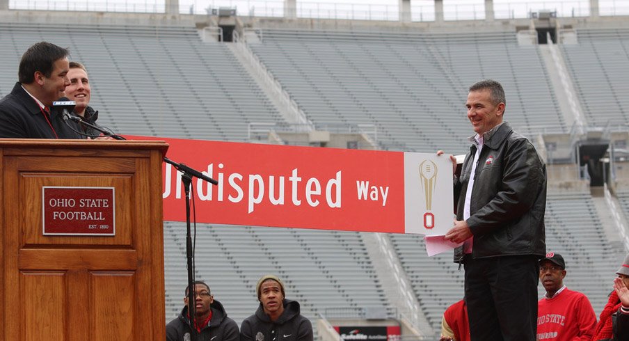 Jeff Heuerman and Urban Meyer hold the new sign, The Undisputed Way