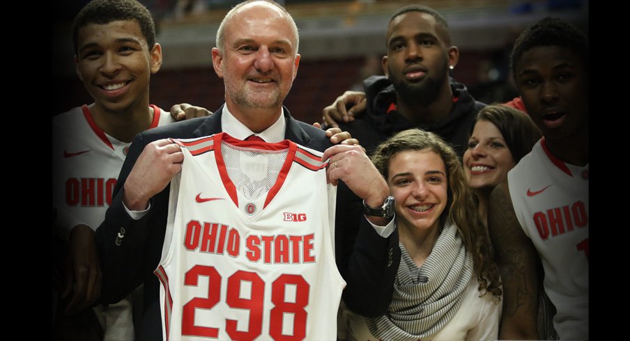 Thad Matta holds up a jersey with No. 298 on it, signifying the number of wins he's amassed as Ohio State's head coach.