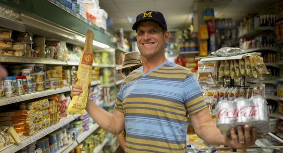 Jim Harbaugh in France, showing off some groceries.