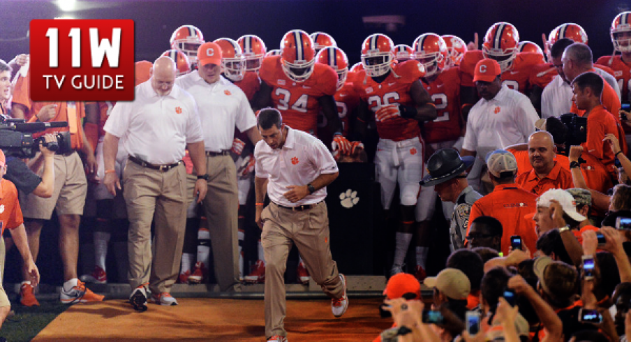 Dabo Swinney leads Clemson's players down the hill for the game against Georgia in 2013.
