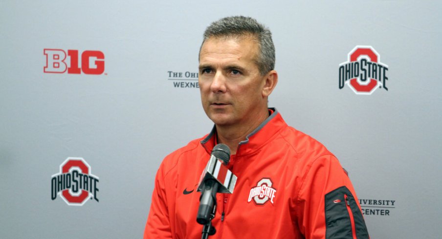 Urban Meyer stands at the podium.