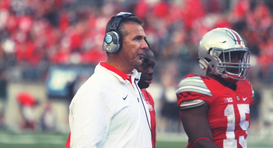 Urban Meyer strolls the sidelines.