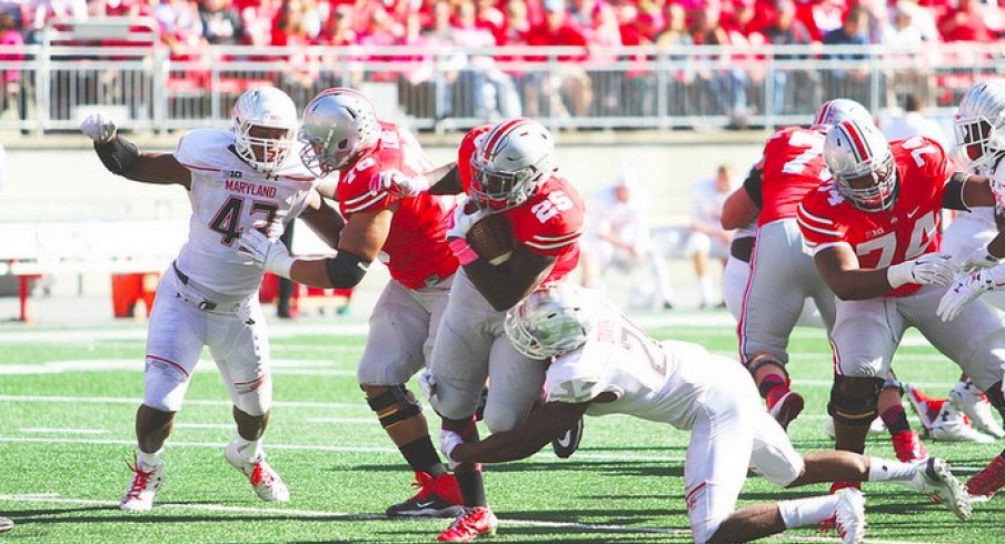 Bri'onte Dunn dragging a Terrapins defender with him.