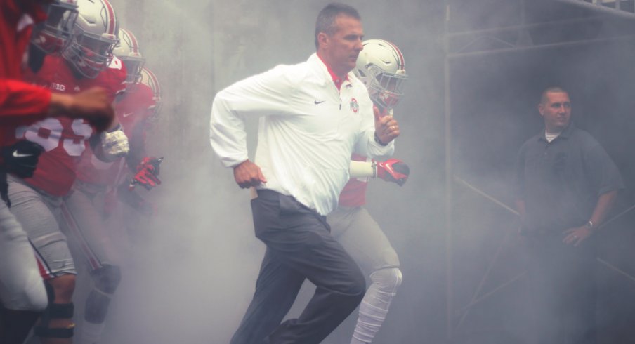 Urban Meyer takes the field. 