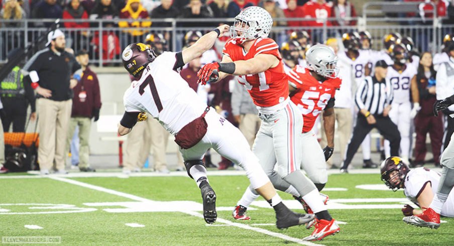 Joey Bosa blasts Minnesota quarterback Mitch Leidner in the first half of Saturday night's game.