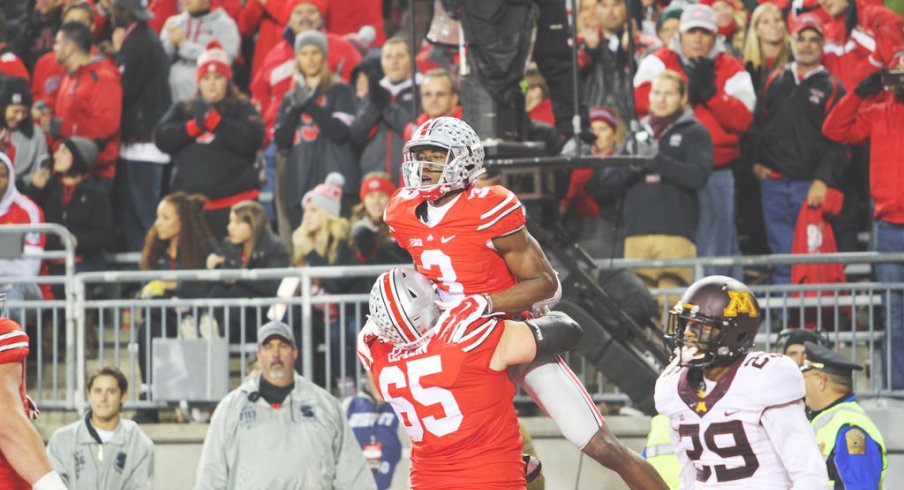 Michael Thomas celebrates a touchdown with Pat Elflein.