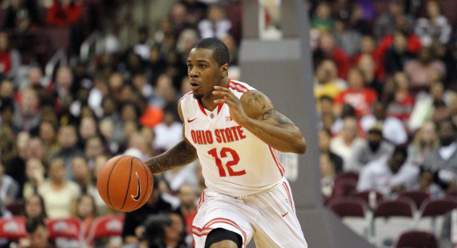 A.J. Harris brings the ball up the floor.