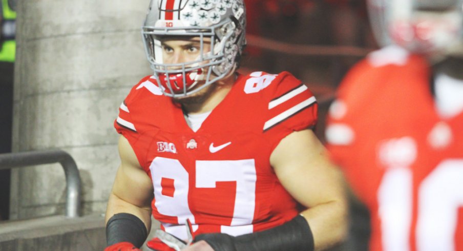 Joey Bosa runs out onto the field. 