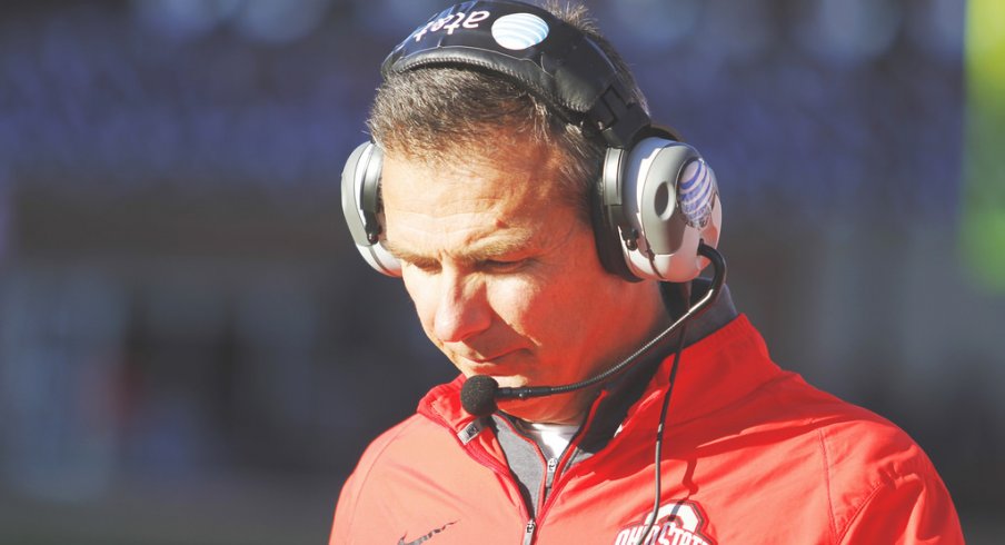 Urban Meyer strolls the sidelines.