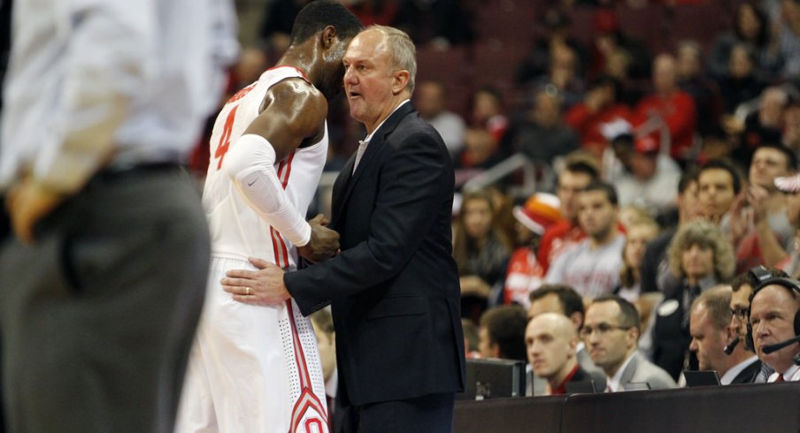 Thad Matta greets Daniel Giddens as he walks off the floor. 