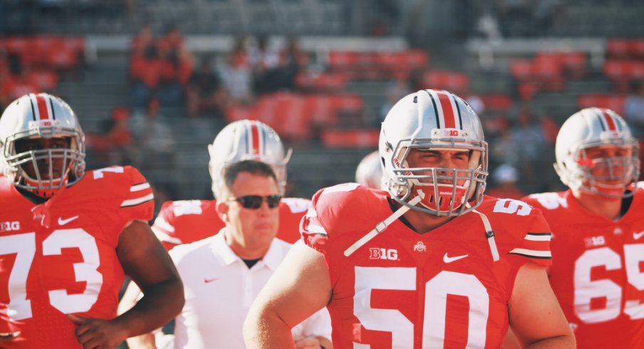 Jacoby Boren leads Ohio State onto the field.