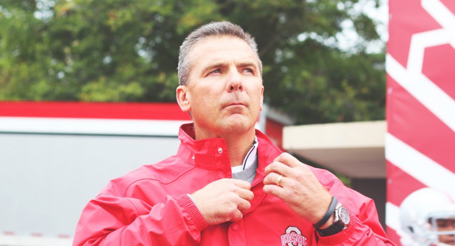 Urban Meyer stands in the rain.