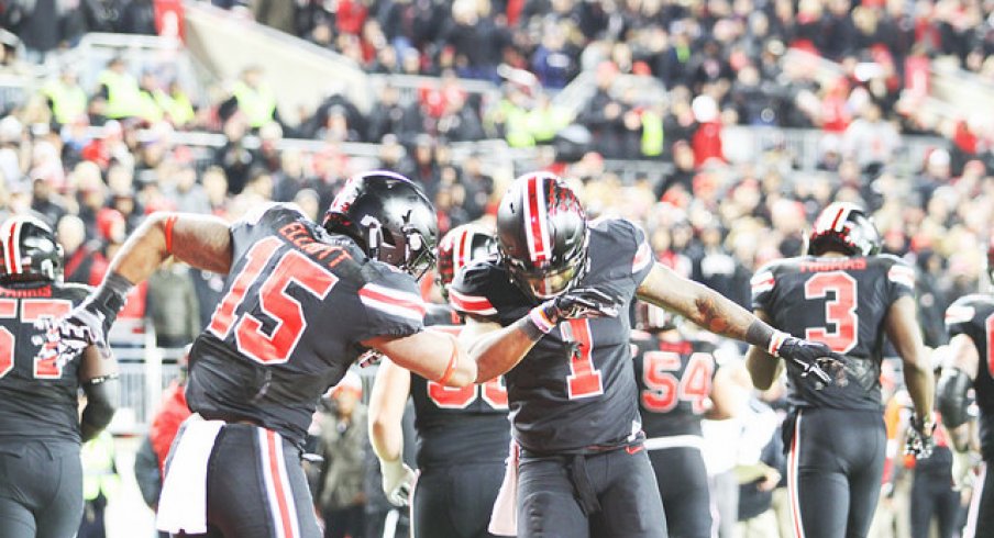 Ezekiel Elliott and Braxton Miller dab on Joe Pa's grave.