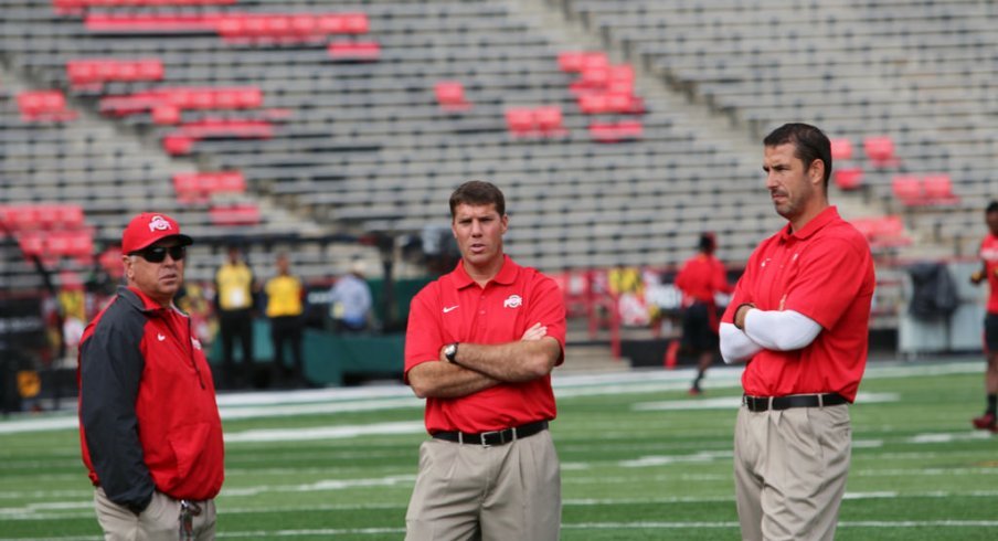 Tim Hinton, Chris Ash and Luke Fickell gathered on the field. 