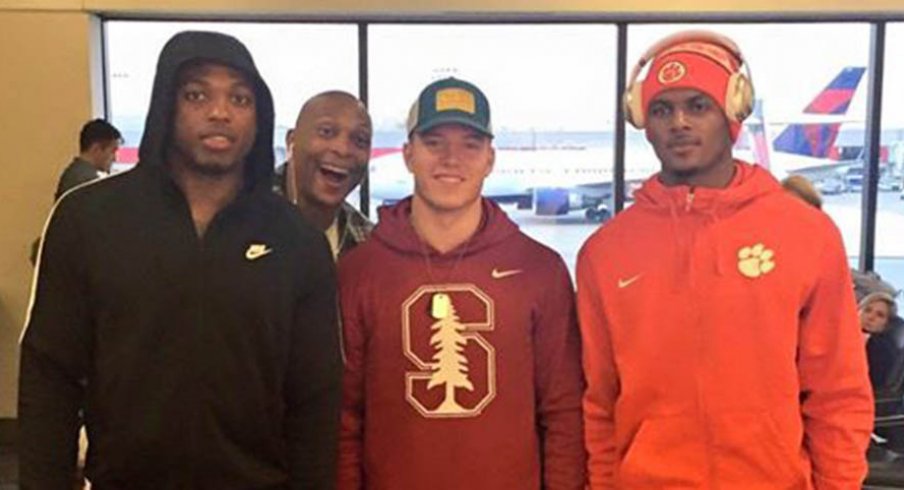 Eddie George photobombed Derrick Henry, Christian McCaffrey and Deshaun Watson at the airport.