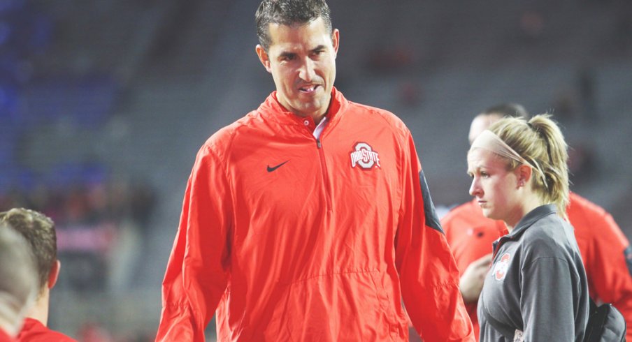 Luke Fickell strolls the sidelines.