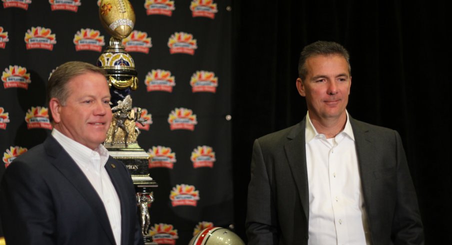 Brian Kelly, Urban Meyer pose with Fiesta Bowl trophy.