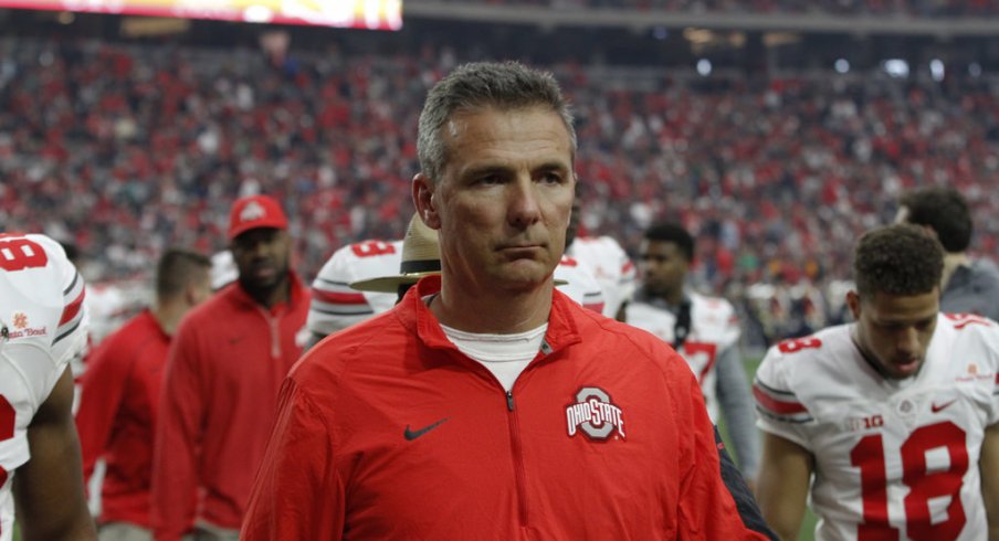 Urban Meyer walks off the field following Ohio State's Fiesta Bowl win.