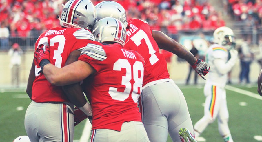 Dante Booker, Craig Fada and Damon Webb celebrate a special teams play against Hawai'i.